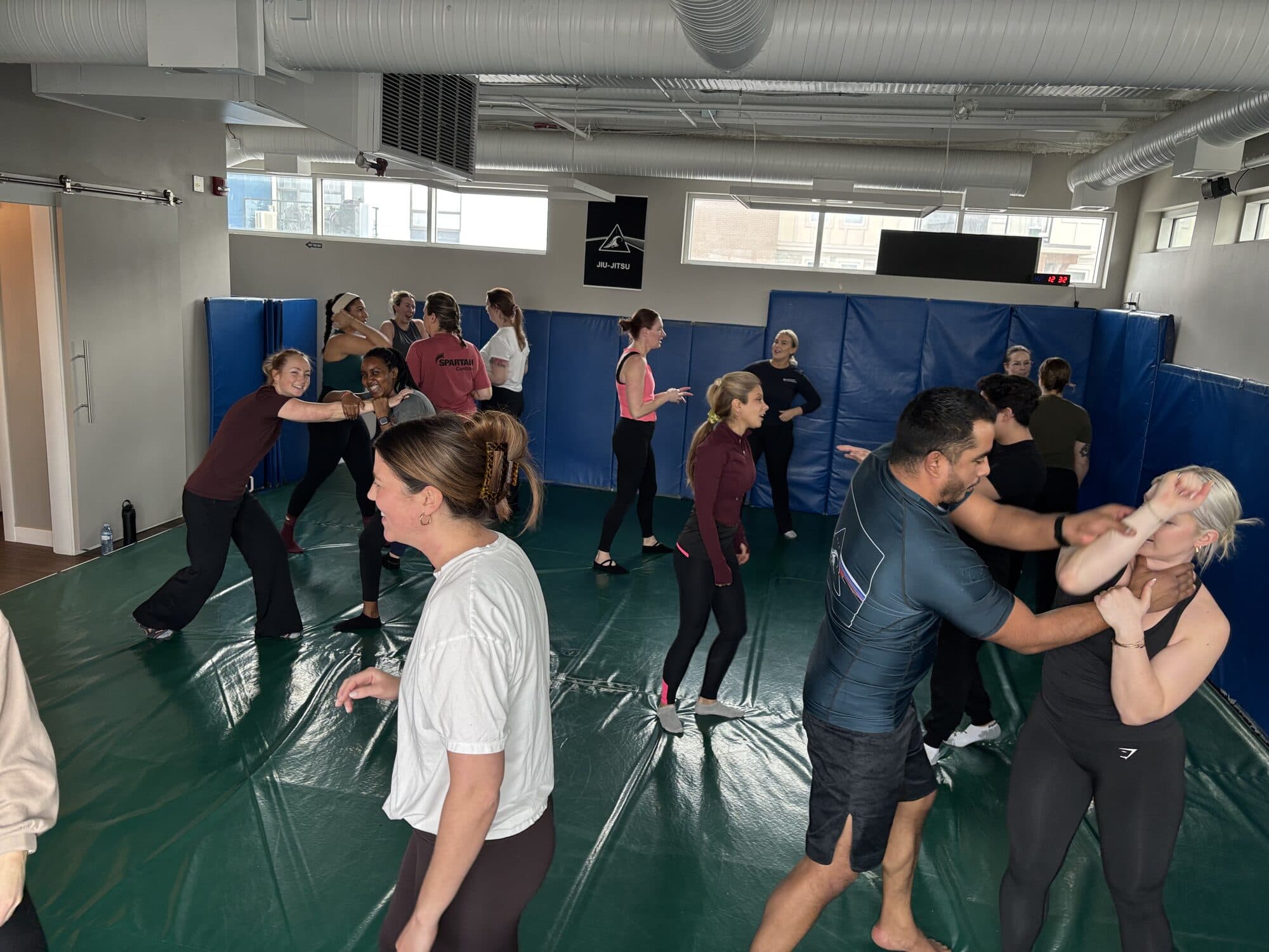 A self-defence technique being practised on the mats at Wiley Jiu-Jitsu YYC in Calgary